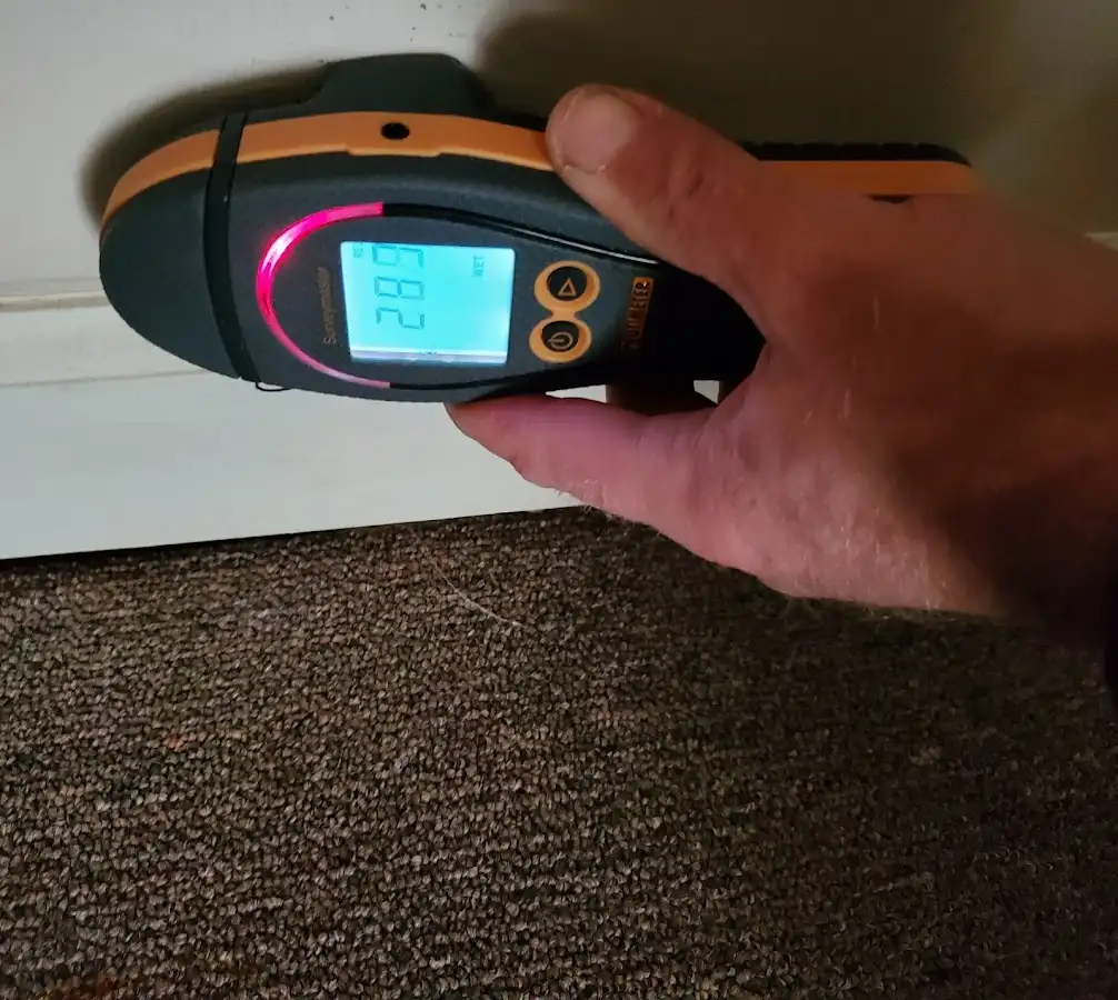 Moisture detection at baseboard during Storm Damage Restoration in Hughson